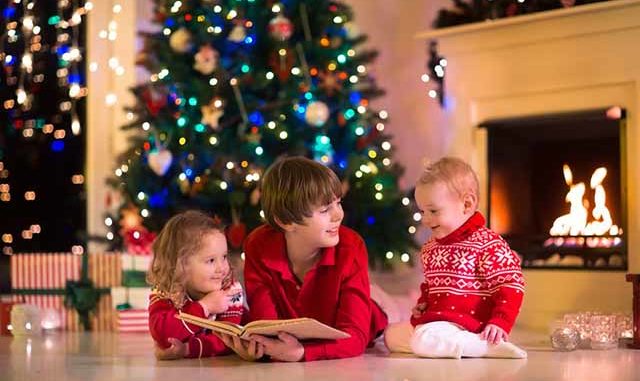 Kids playing at fireplace on Christmas eve