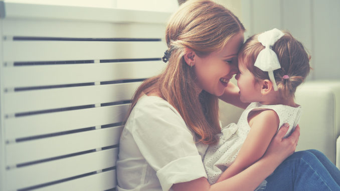 Happy loving family. mother and child playing, kissing and hugging