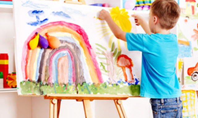 Child painting at easel.